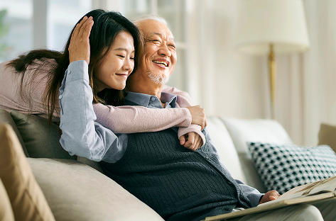 Family embracing on couch
