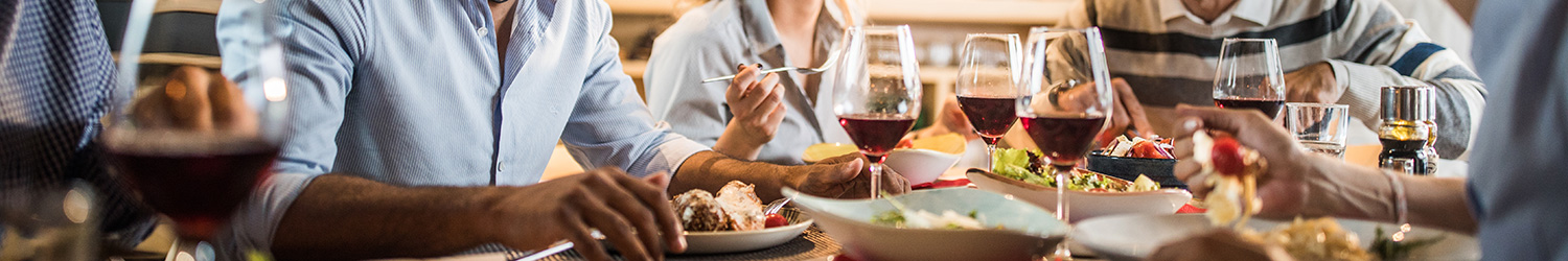 Group of people eating dinner with wine