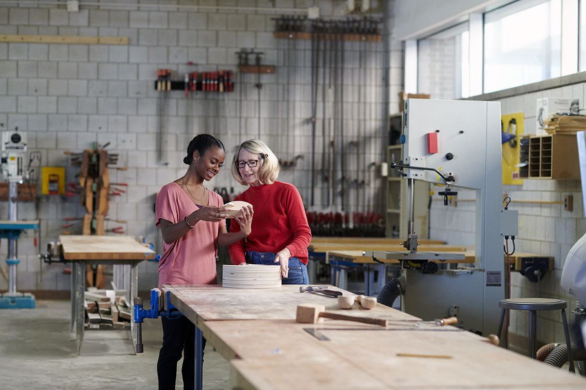 Senior and student taking a woodshop class