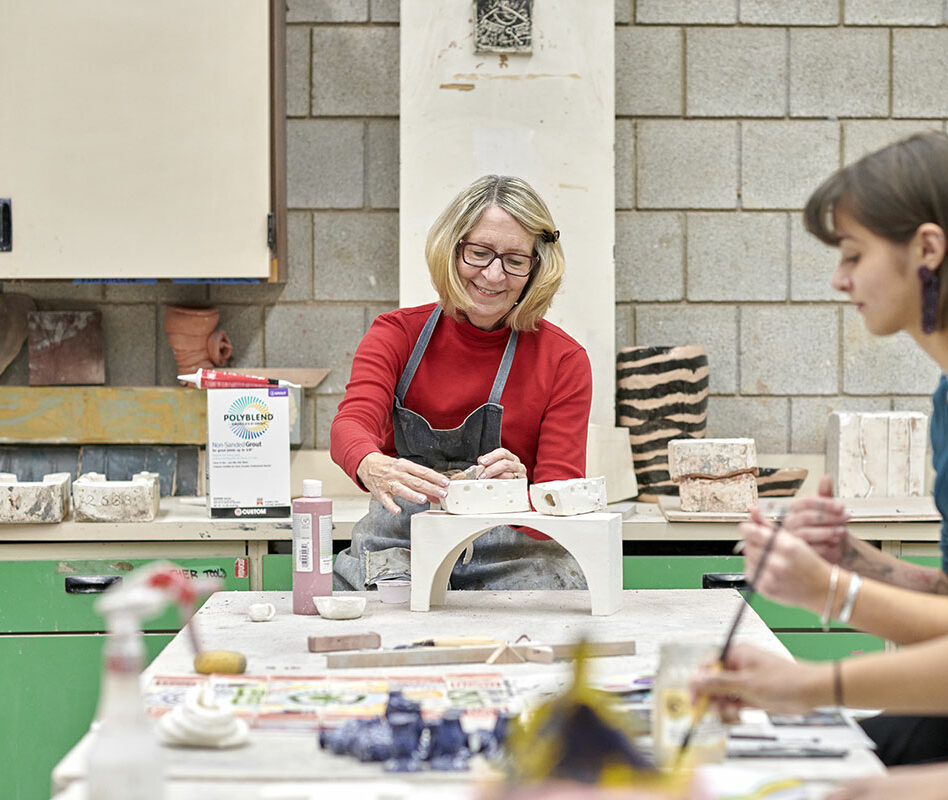 Senior and student at Pottery class for intergenerational learning