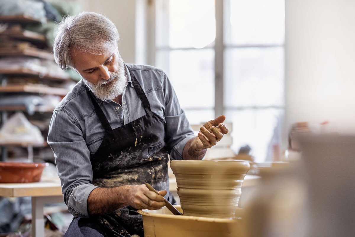 Senior man doing pottery in a pottery class
