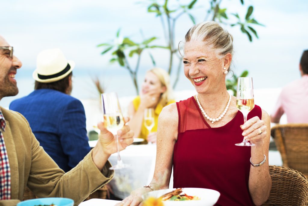 Senior woman enjoying a glass of wine outdoors