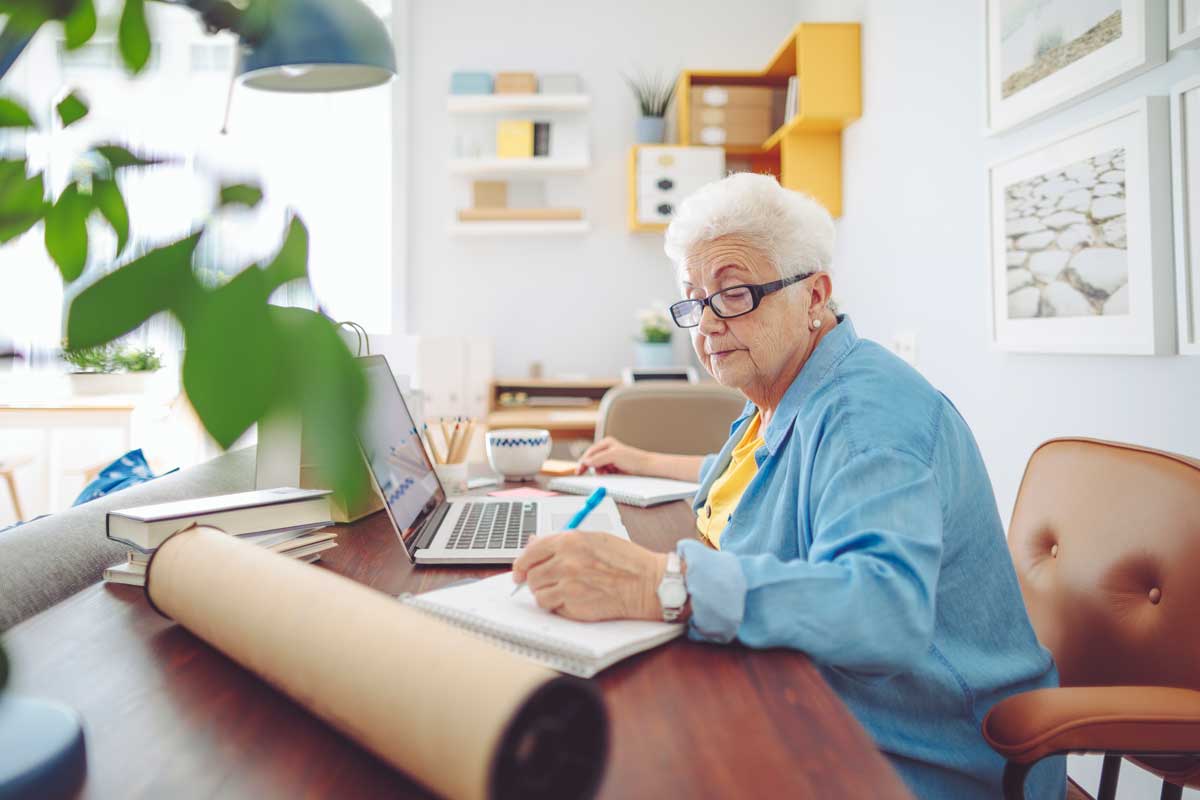 Senior woman uses technology to keep track of her finances.