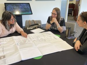 Executive Director Ashley Wade and Kepko Inspecting New Construction Blueprints Of Broadview