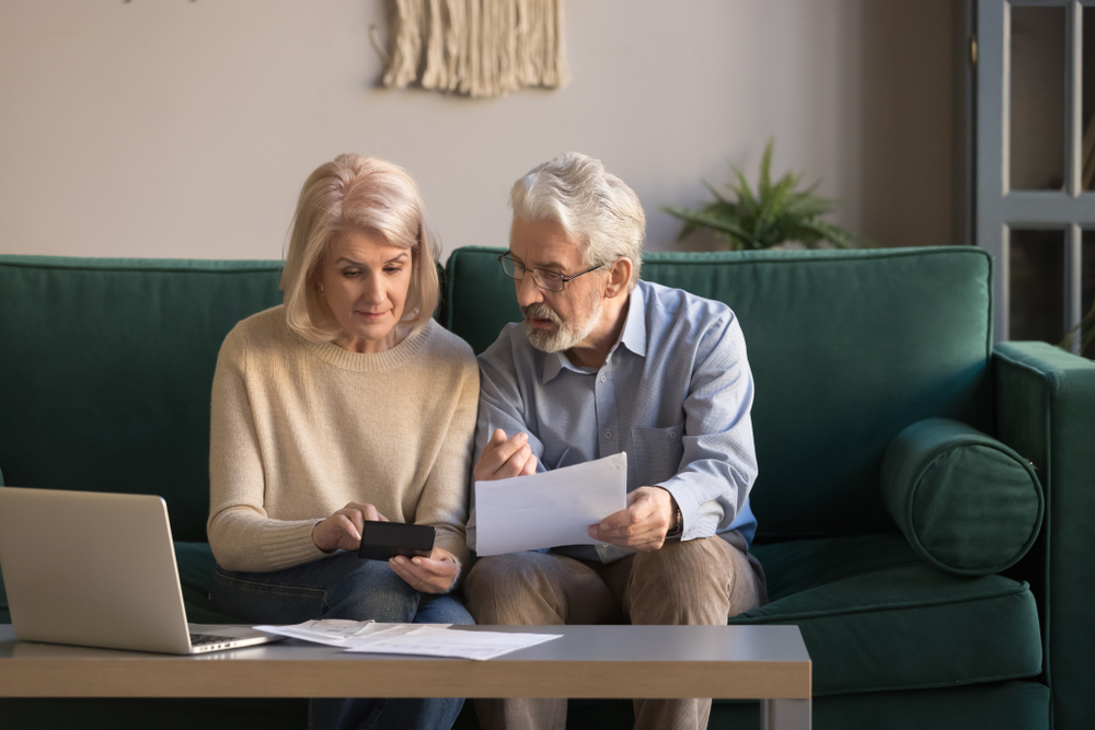 Senior couple looking at paperwork regarding retirement planning
