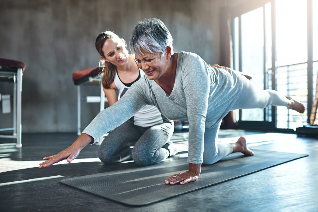 Senior woman working out with her physiotherapist